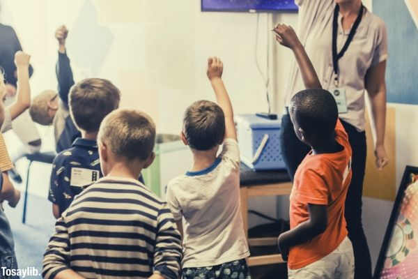 teacher students raising hands