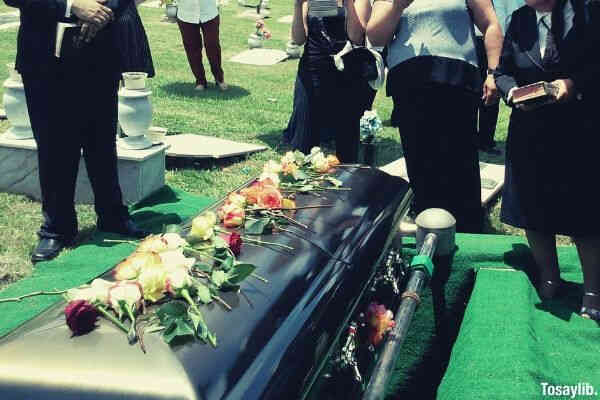 black casket funeral people