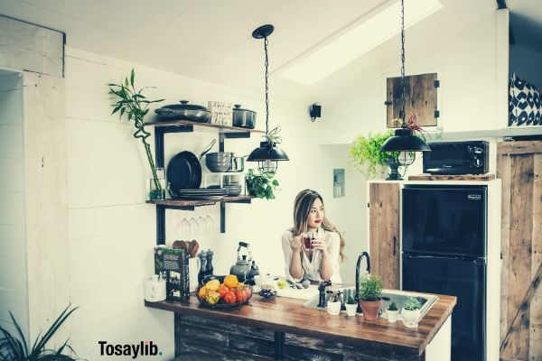 woman sitting in front of the table drinking coffee