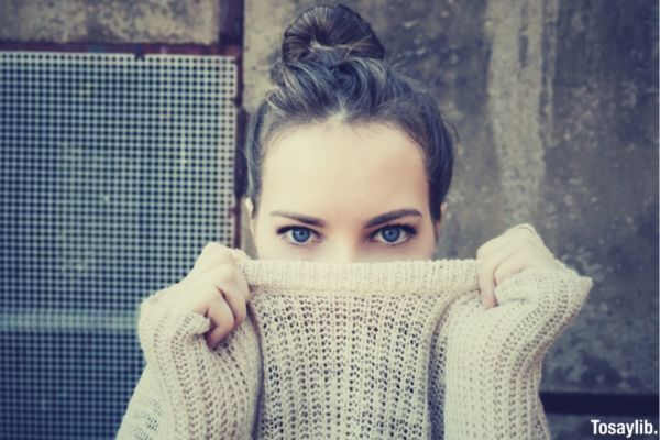 woman sweater hiding blue eyes