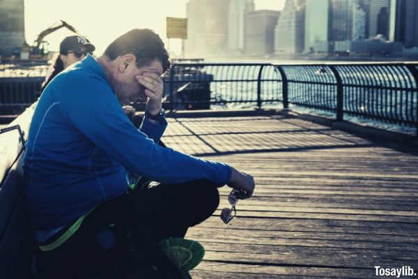 man sitting on the bench crying