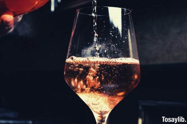 pouring liquor on wine glass