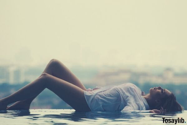 woman lying on the pool daytime