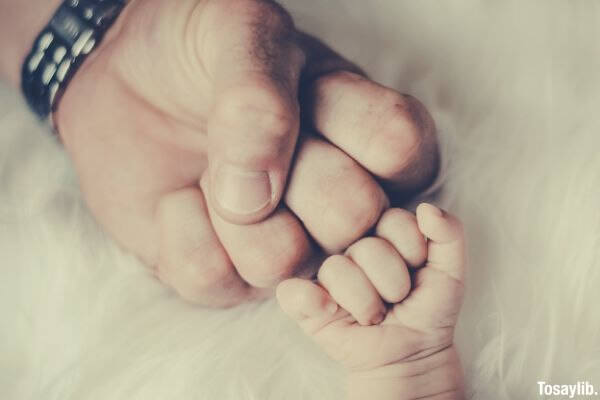 father and baby s fist