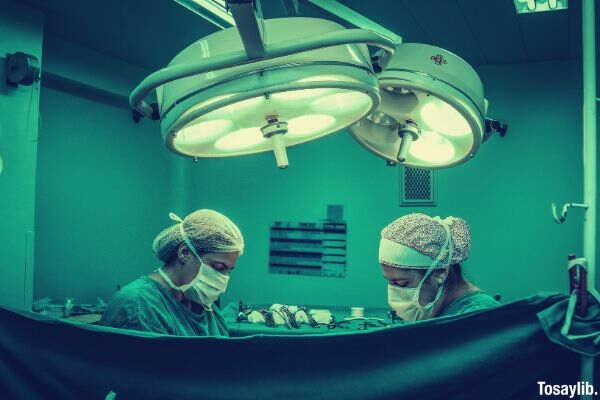 two person doing surgery inside room
