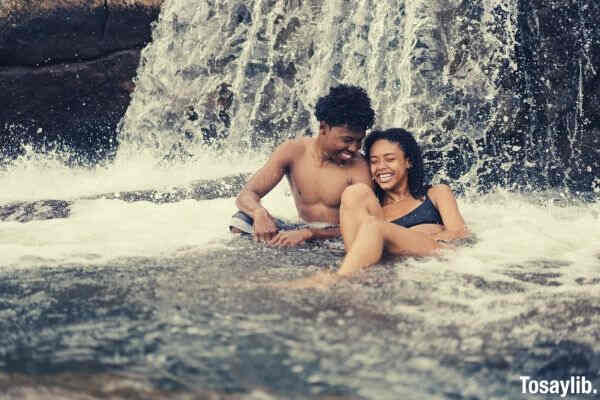 couple swimming falls smiling talking