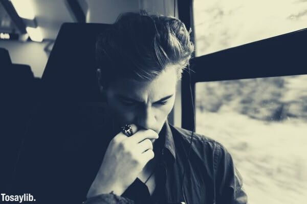 black and white photo of a man riding bus