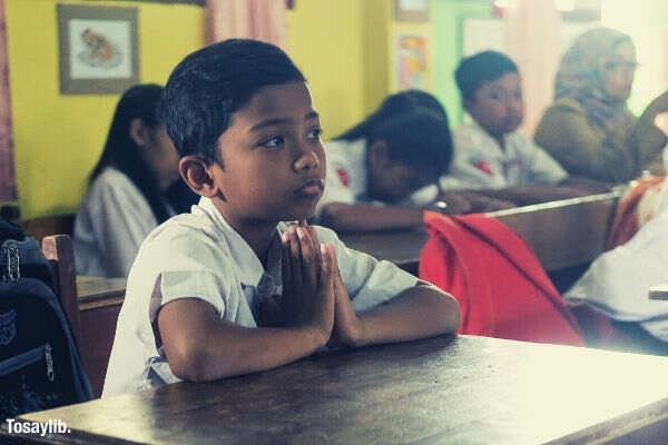 boy concentration young kids student studying students indonesian school uniform in class