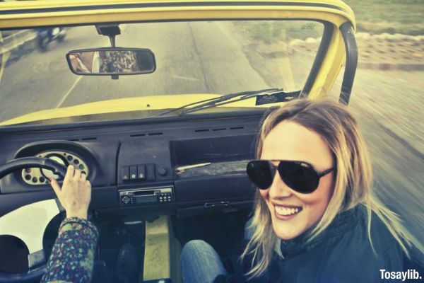 woman in black aviator sunglasses sitting on car s passenger seat