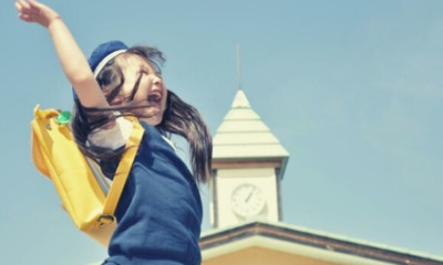 happy-girl-yellow-bag-sky
