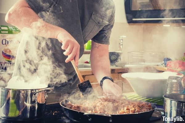 man cooking food kitchen steam