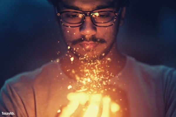 man holding light wearing eye glass