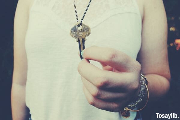 man holding key pendant photo