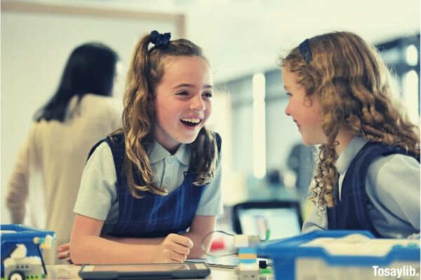 two girls laughing school