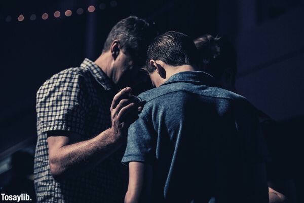 group of men praying over