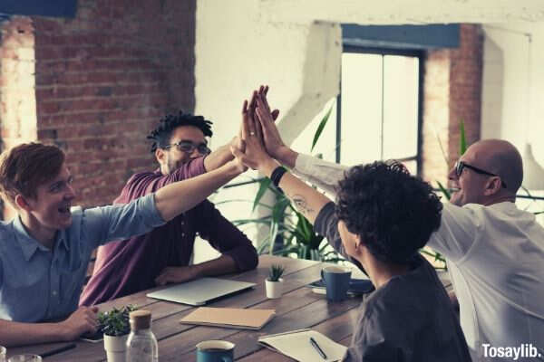 photo of people holding each other s hands