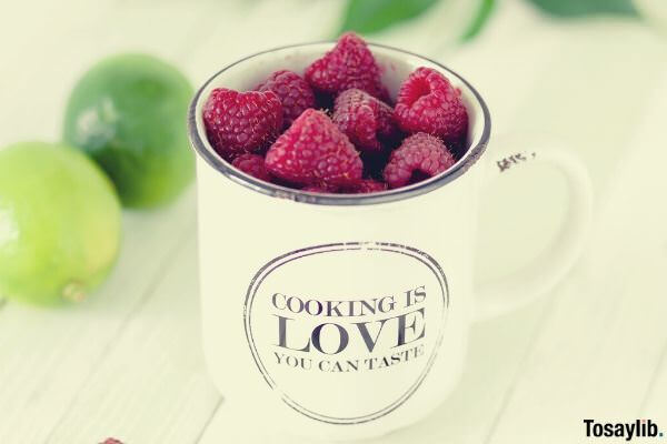 red fruit in white mug