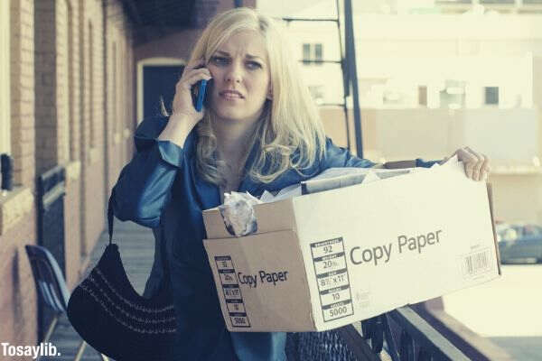 a woman carrying a cardboard box