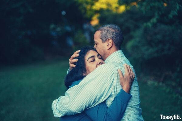 old couple hug eyes closed