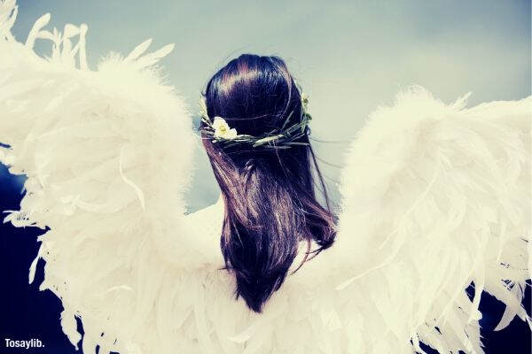 woman wearing white angel wings