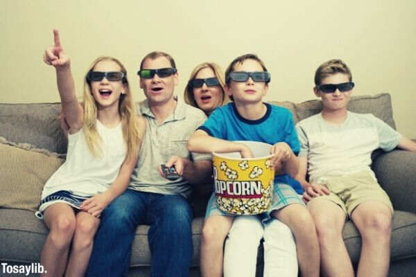 family watching movie eating popcorn