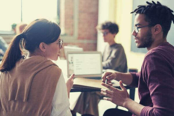 photo of man talking to a woman