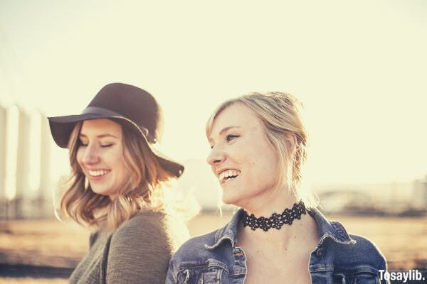 two women taking a side view selfie