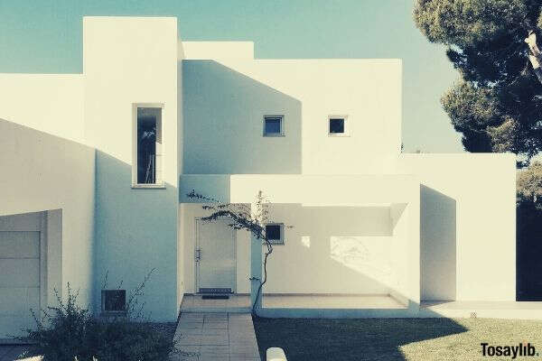 white 2 storey house near trees