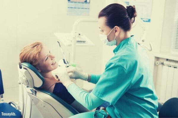 dental clinic dentist cleaning patients teeth woman