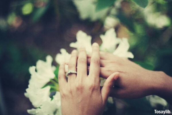 person holding flowers ring