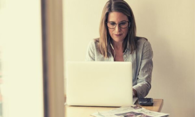 woman-with-gray-glasses-working-on-laptop