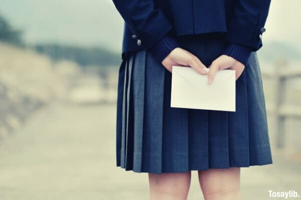 japanese shoolgirl holding an envelope