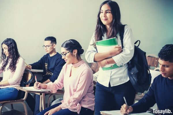 woman standing in the middle of class