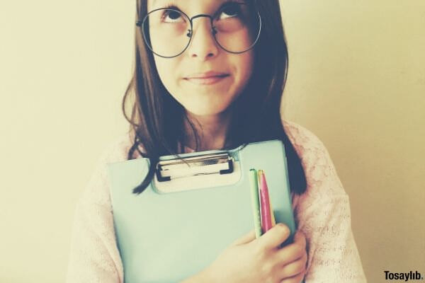 girl in eyeglasses holding paperworks