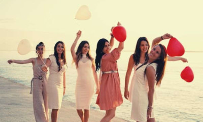 group-of-women-holding-balloons-sea