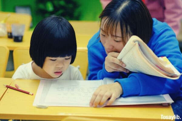 woman teaching girl