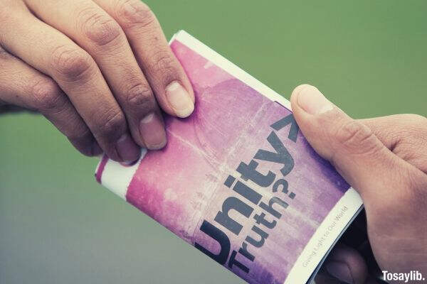 05 close up photo of two hands holding leaflet