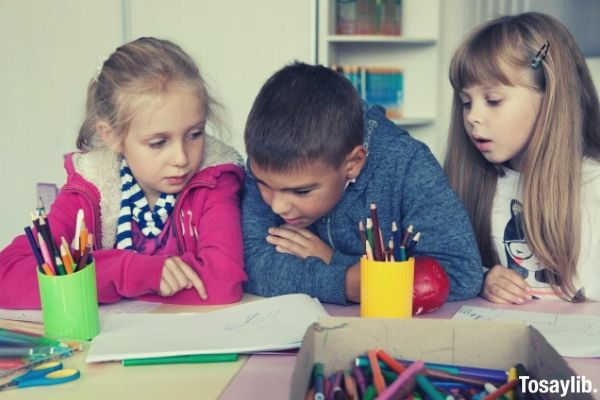 elementary school student studying on one desk