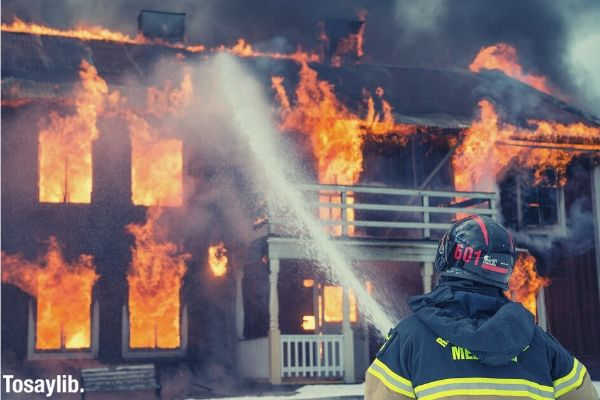fireman watering the fire inside the house