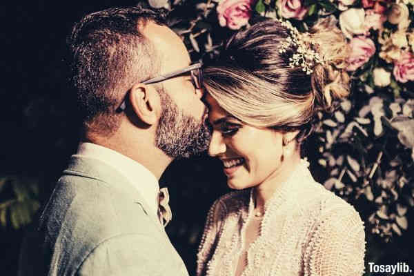 newly wed man kissing woman s forehead