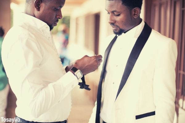 best man getting the groom ready