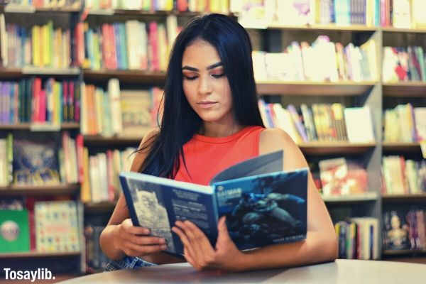 sitting woman standing book in library