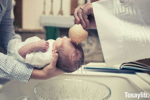 photo of a toddler getting baptized