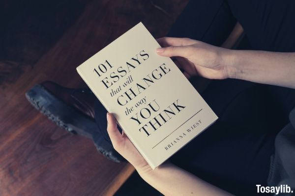 person holding 101 essay that will change the way you think