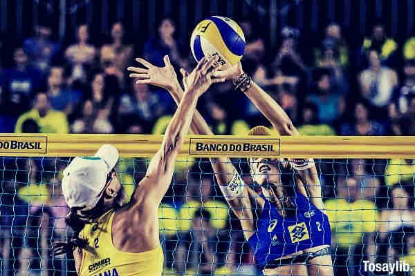 two women playing volleyball