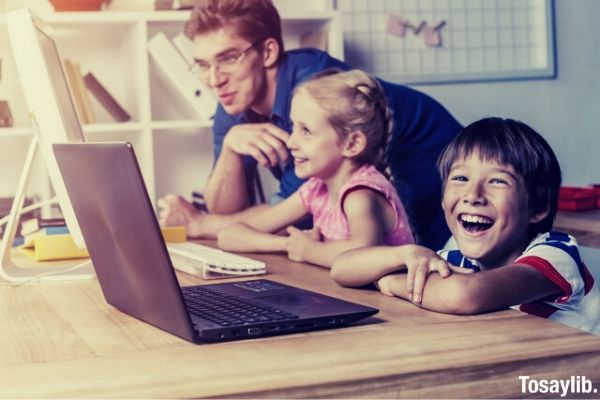 kids boy smiling in front of laptop
