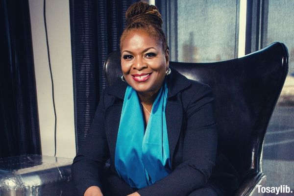 01 woman in blue blouse sitting on black chair