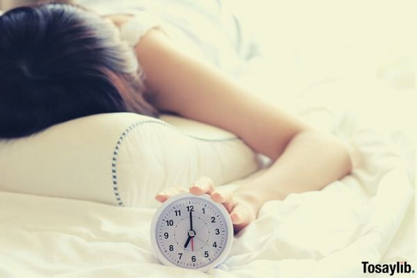 woman holding alarm clock