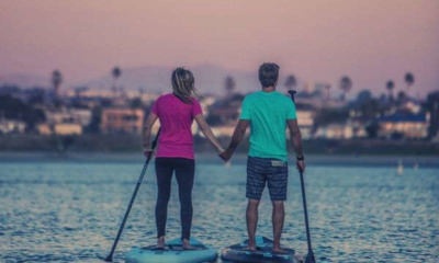 man-and-woman-standing-on-a-paddle