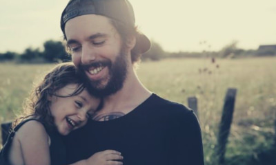 man-in-black-shirt-carrying-his-daughter